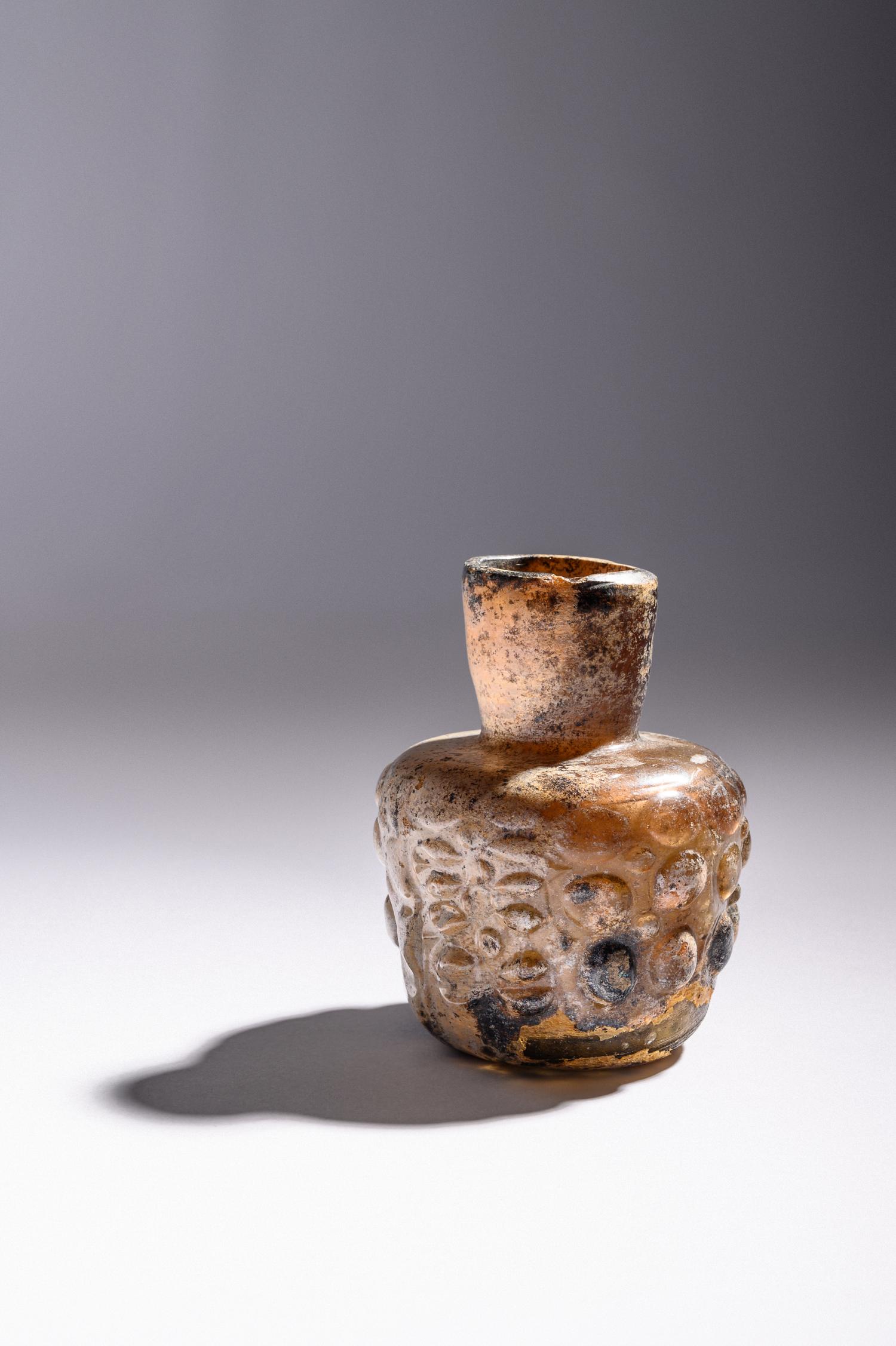 An Islamic Dark Yellow Glass Flask