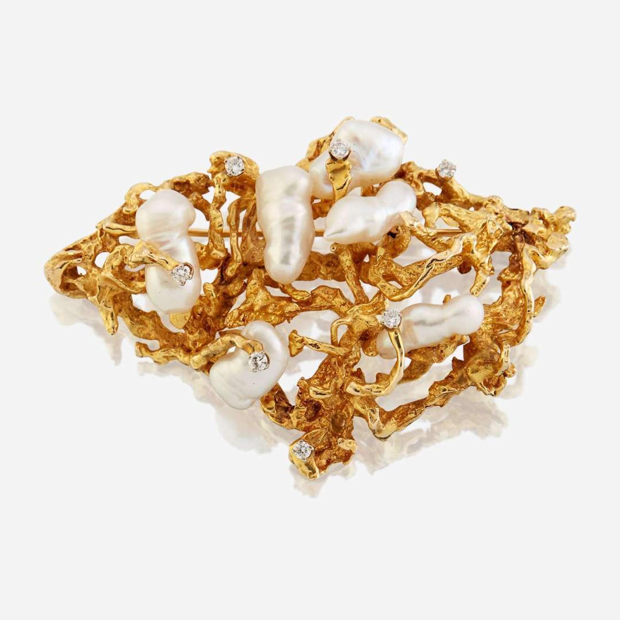 A fourteen karat gold, cultured pearl, and diamond brooch