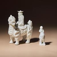 Two Chinese Blanc-de-Chine Porcelain Figural Groups of Foreigners Riding on Qilin, Late 17th-Early 18th Century — 清中期 德化白瓷骑麒麟西人像兩件