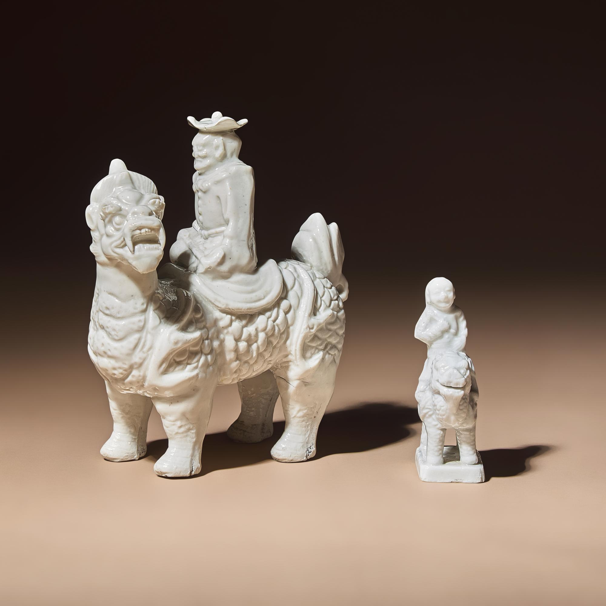 Two Chinese Blanc-de-Chine Porcelain Figural Groups of Foreigners Riding on Qilin, Late 17th-Early 18th Century — 清中期 德化白瓷骑麒麟西人像兩件