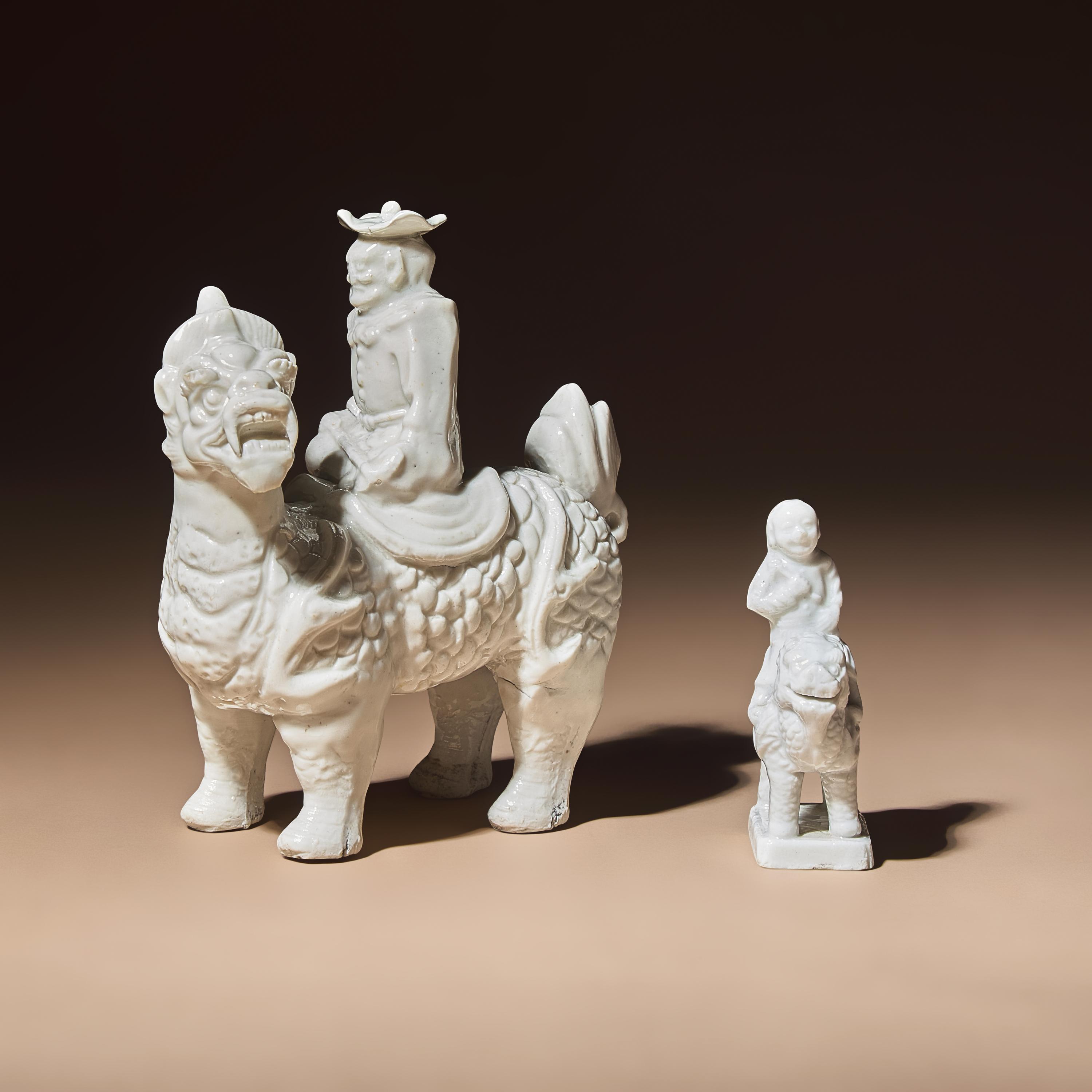 Two Chinese Blanc-de-Chine Porcelain Figural Groups of Foreigners Riding on Qilin, Late 17th-Early 18th Century — 清中期 德化白瓷骑麒麟西人像兩件