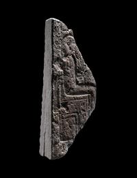 An Egyptian Limestone Stele Fragment with a Seated Pharaoh