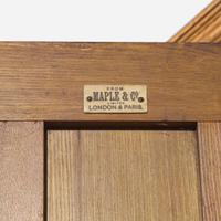 A large English Aesthetic Movement oak wardrobe Attributed to Richard Norman Shaw (1831-1912) & William Eden Nesfield (1835-1888), retailed by Maple & Co. (est. 1841), London, England, circa 1870