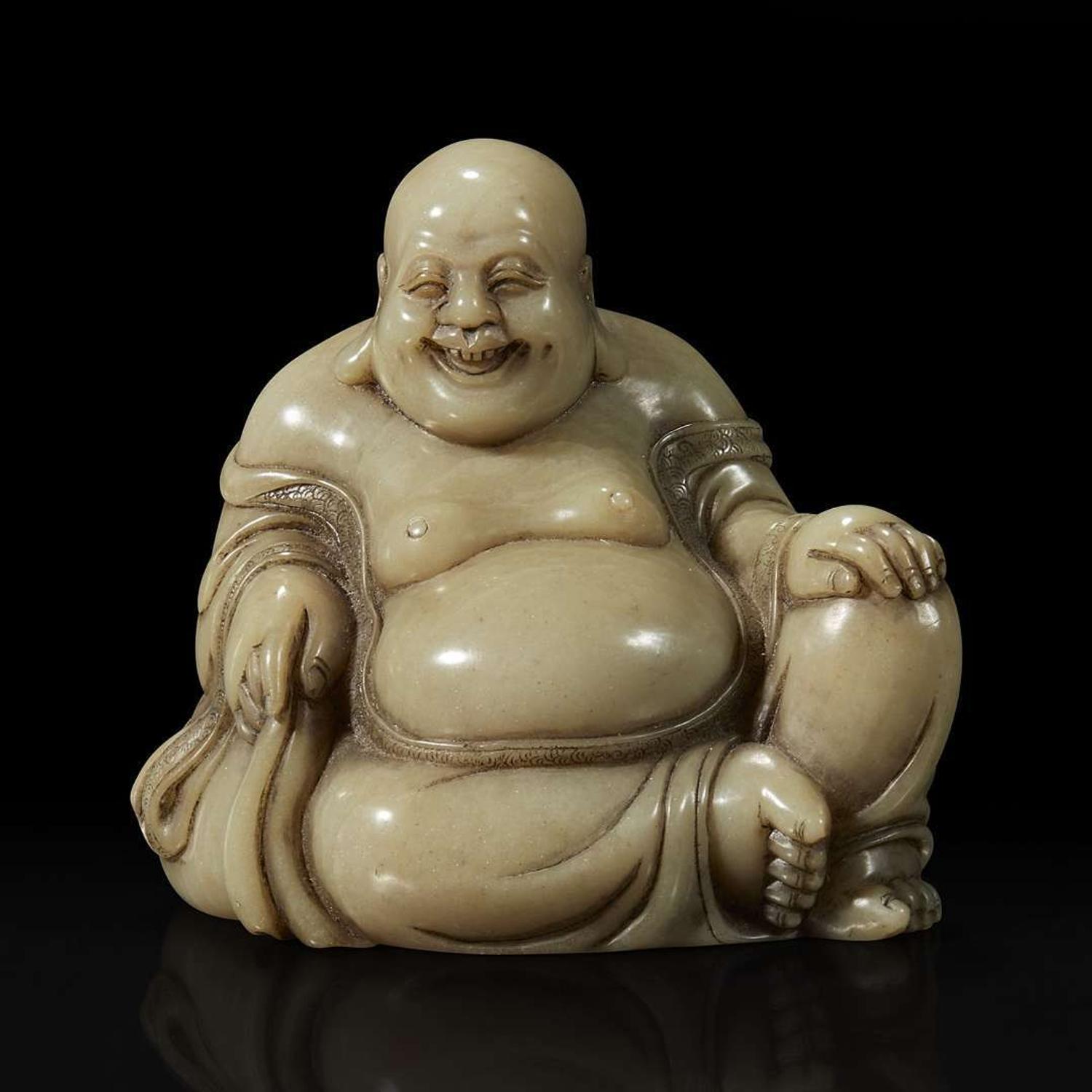 A Chinese carved soapstone figure of a seated Budai 寿山石雕布袋和尚