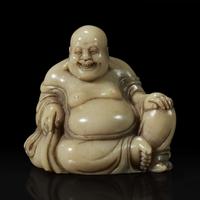 A Chinese carved soapstone figure of a seated Budai 寿山石雕布袋和尚
