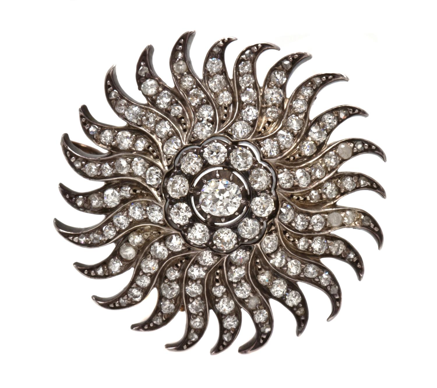 A Silver Topped Gold and Diamond Sunburst Pendant/Brooch, 11.30 dwts.