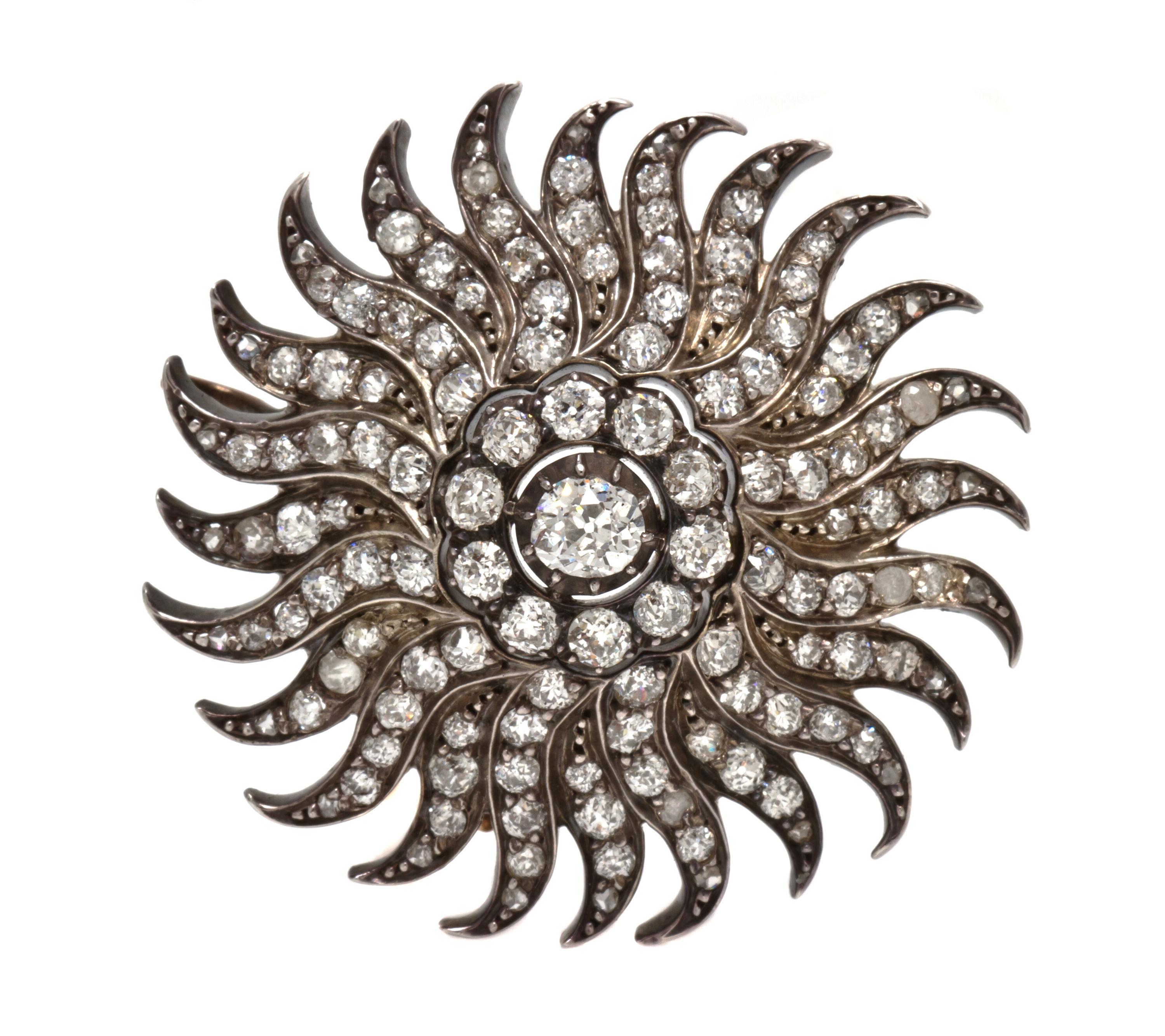 A Silver Topped Gold and Diamond Sunburst Pendant/Brooch, 11.30 dwts.