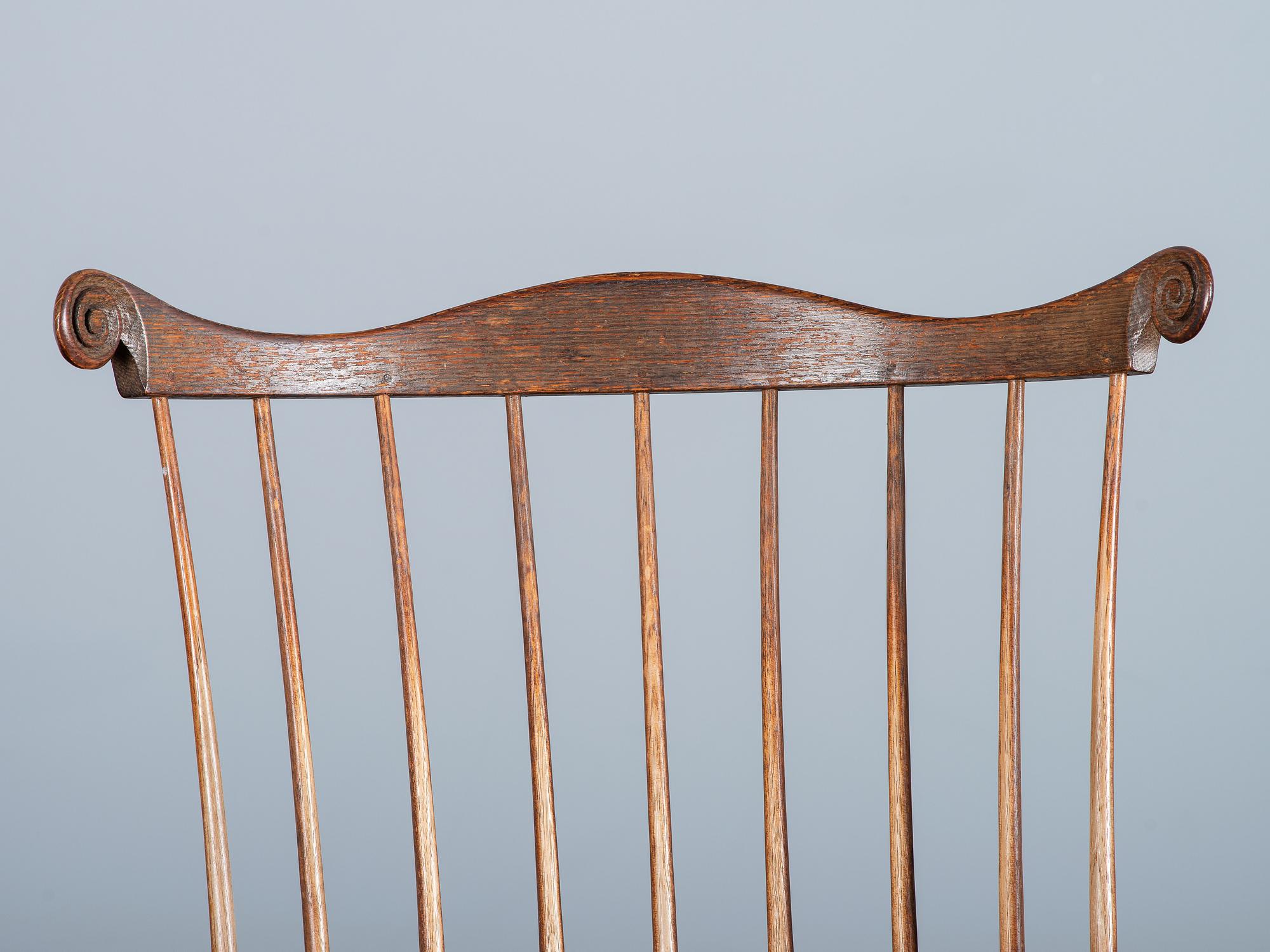 A Volute and Scroll Carved and Reel Turned Windsor Armchair