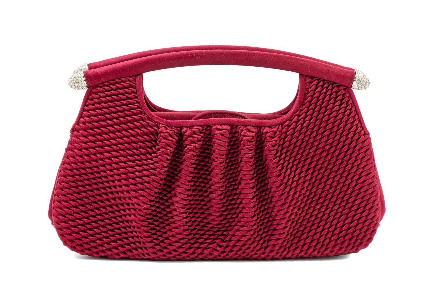 A Judith Leiber Bordeaux Satin Textured Clutch, 8" x 4.5" x 1.5".