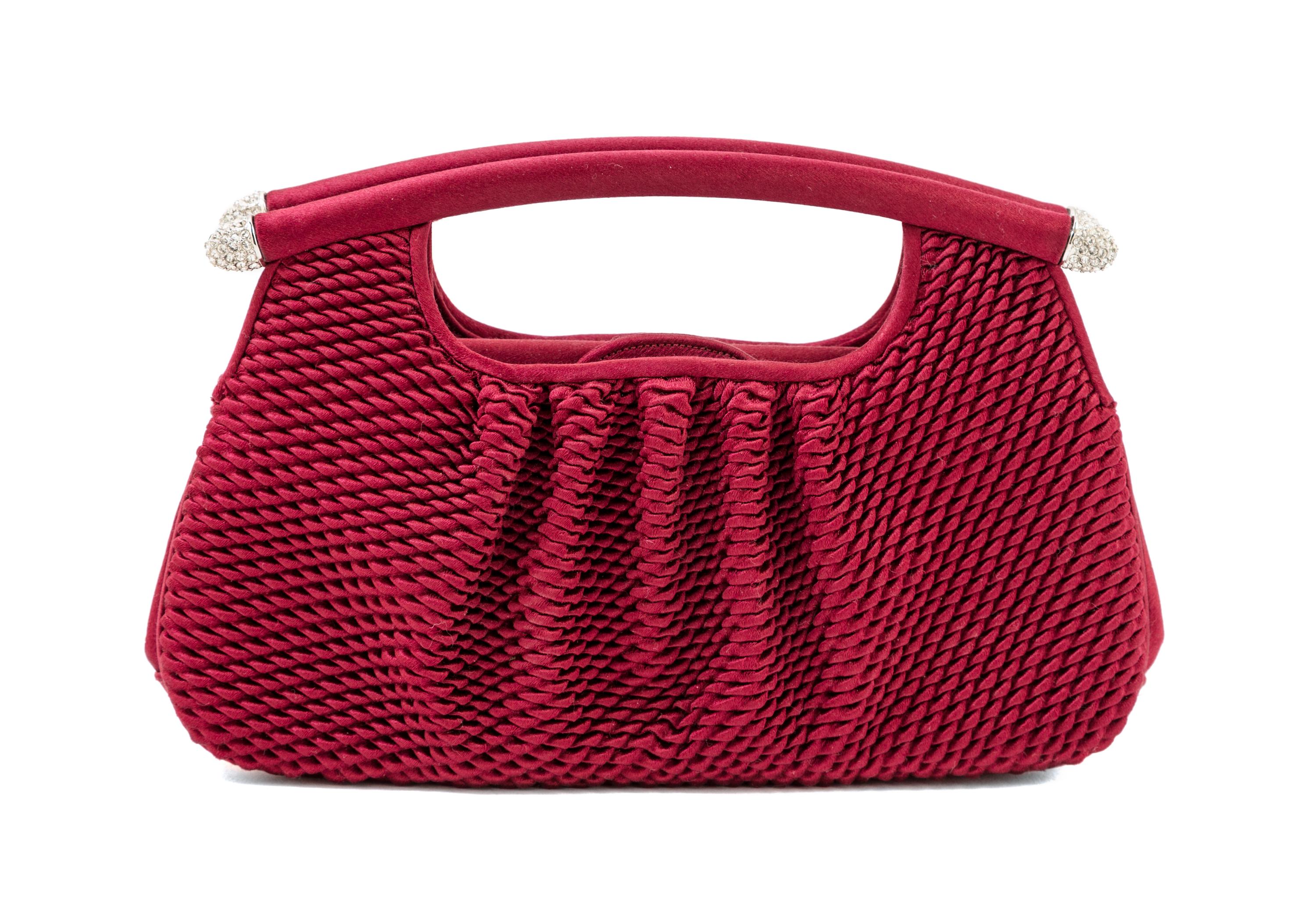 A Judith Leiber Bordeaux Satin Textured Clutch, 8" x 4.5" x 1.5".