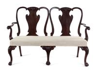 A George III Carved and Figured Mahogany Double-Chair Back Settee