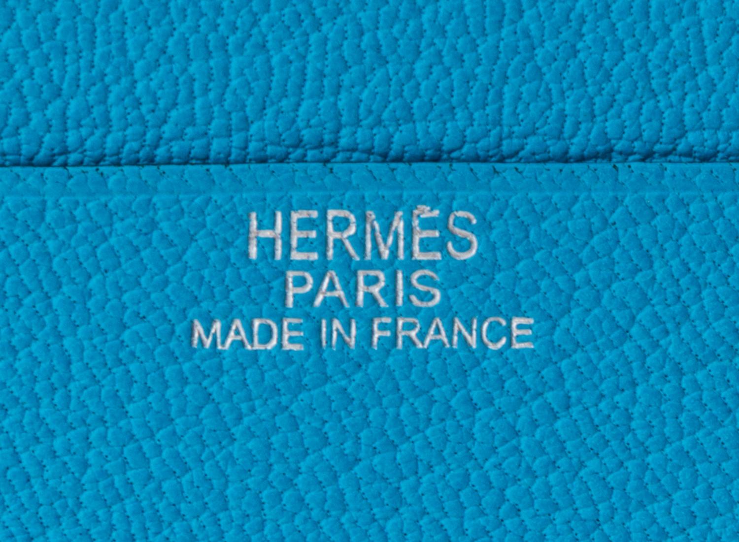 An Hermes Saint Cyr Blue Leather Evelyne Wallet, 4" x 4" x .25".