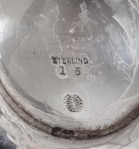 An American Silver Chocolate Pot, Tuttle Silversmiths, Boston, MA, of baluster form with a wood handle and a circular foot.
