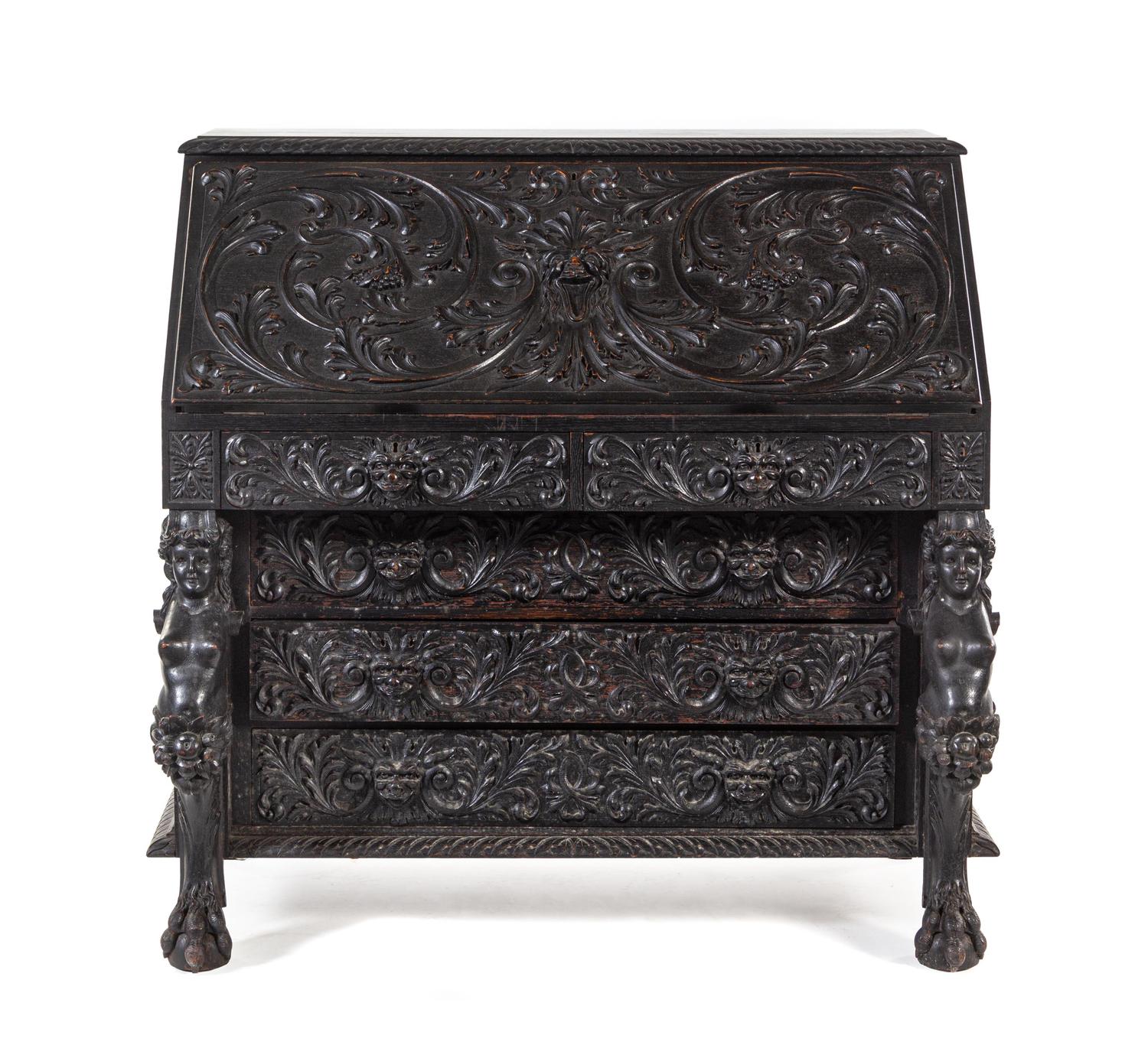 A Renaissance Revival Carved Slant-Front Desk