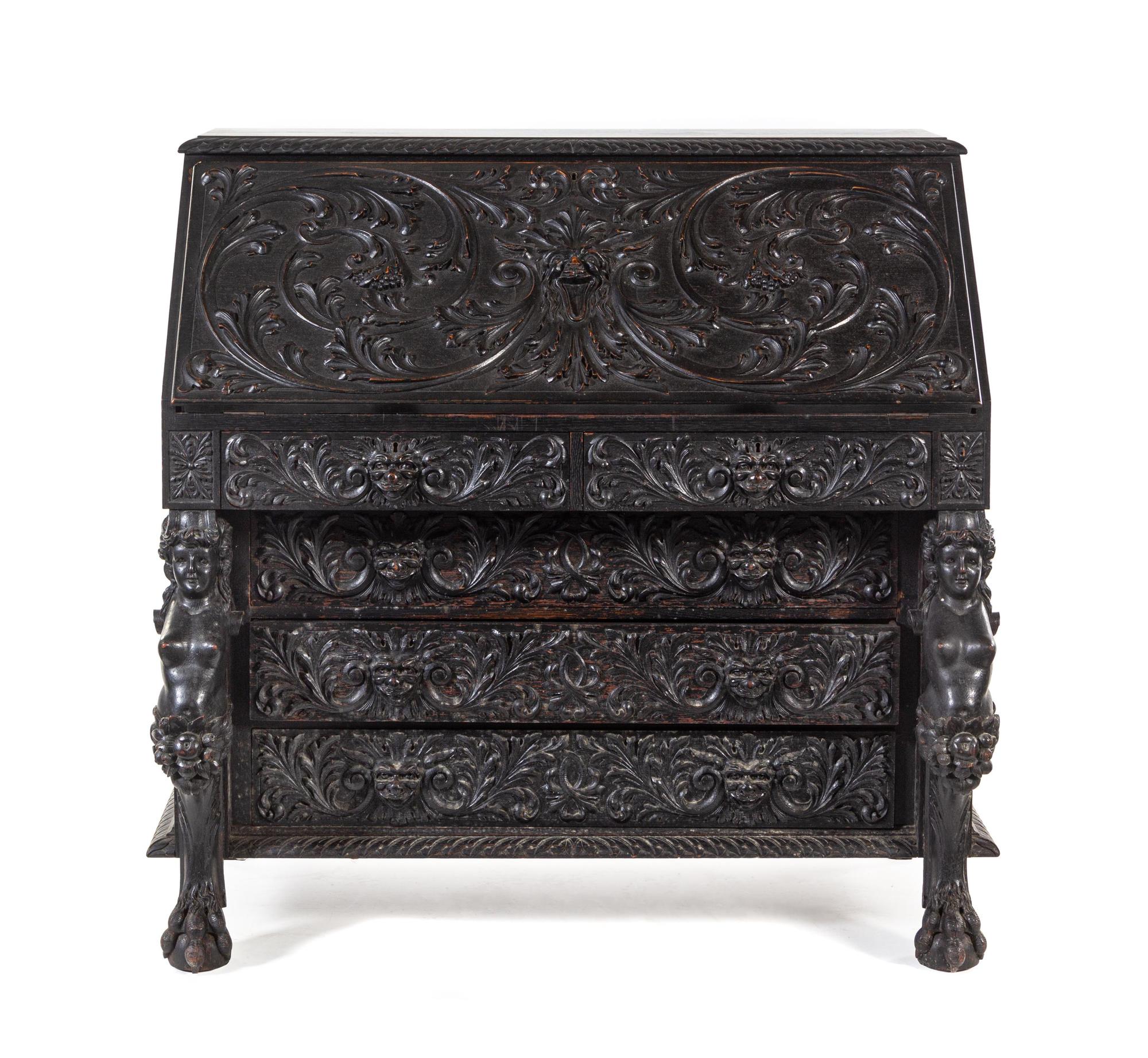 A Renaissance Revival Carved Slant-Front Desk