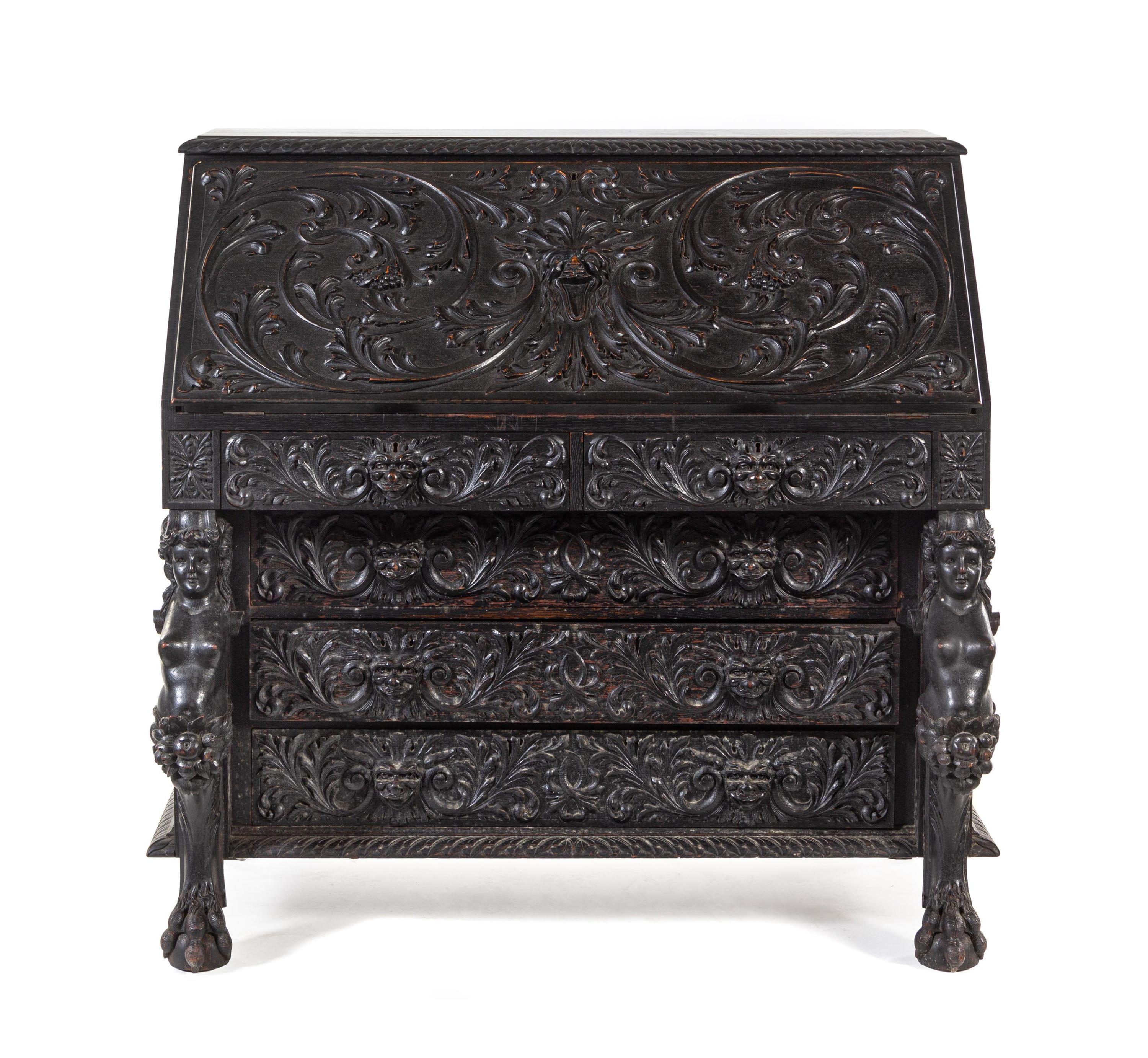 A Renaissance Revival Carved Slant-Front Desk