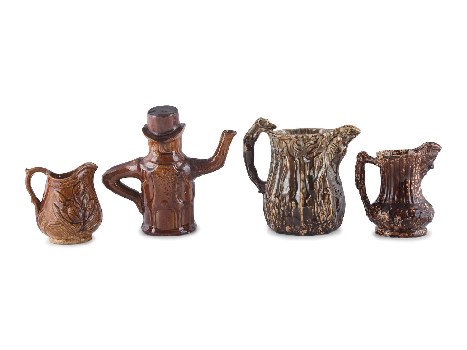 A Group of Molded Teapots and Jugs in Rockingham Glaze