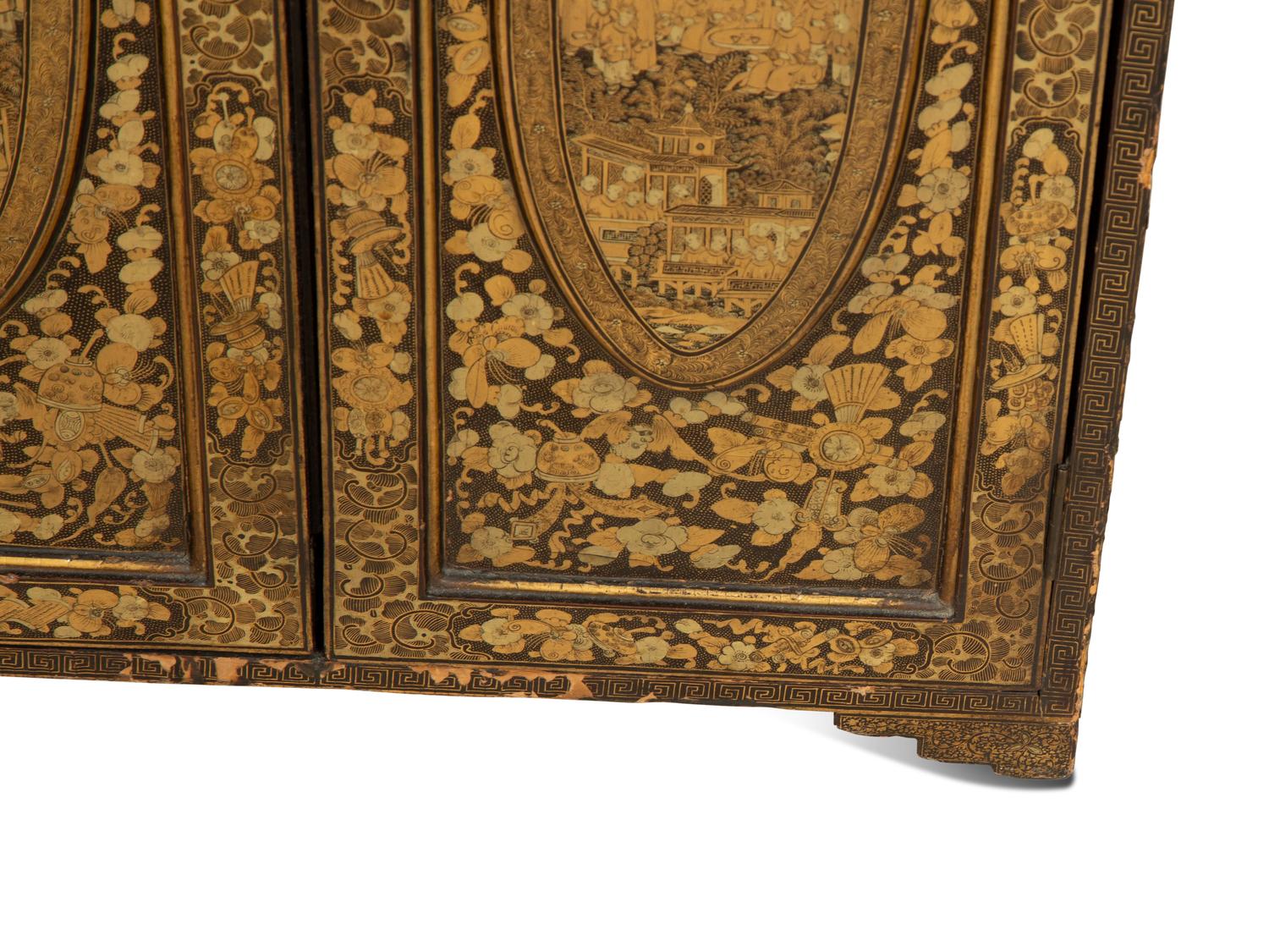 An English Black and Gilt Chinoiserie Decorated Cabinet with Interior Drawers