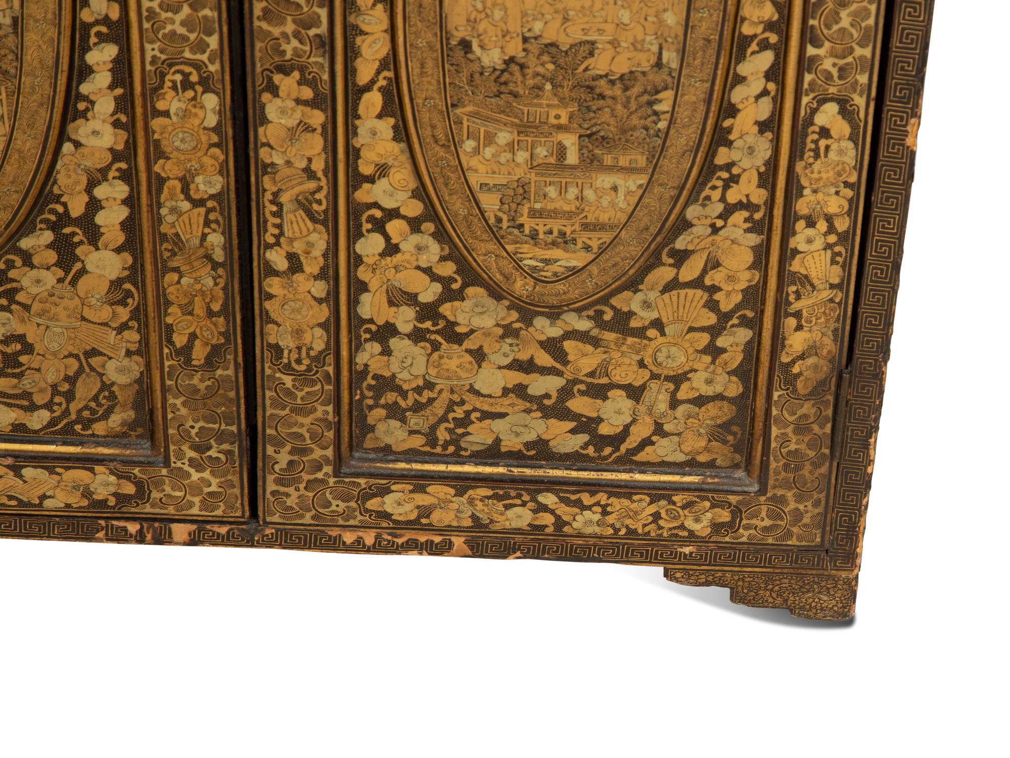 An English Black and Gilt Chinoiserie Decorated Cabinet with Interior Drawers