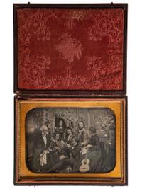 [EARLY PHOTOGRAPHY]. Half plate daguerreotype scene of a group of playful musicians and guests posed together with diverse instruments before a detailed studio backdrop.