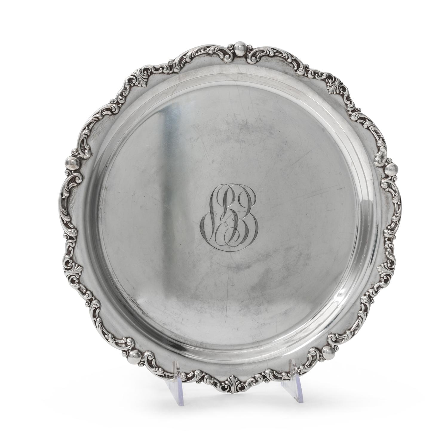 An American Silver Tray, Gorham Mfg. Co., Providence, RI, of circular form with an applied foliate scroll border surrounding a script m