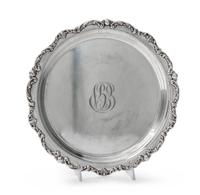 An American Silver Tray, Gorham Mfg. Co., Providence, RI, of circular form with an applied foliate scroll border surrounding a script m