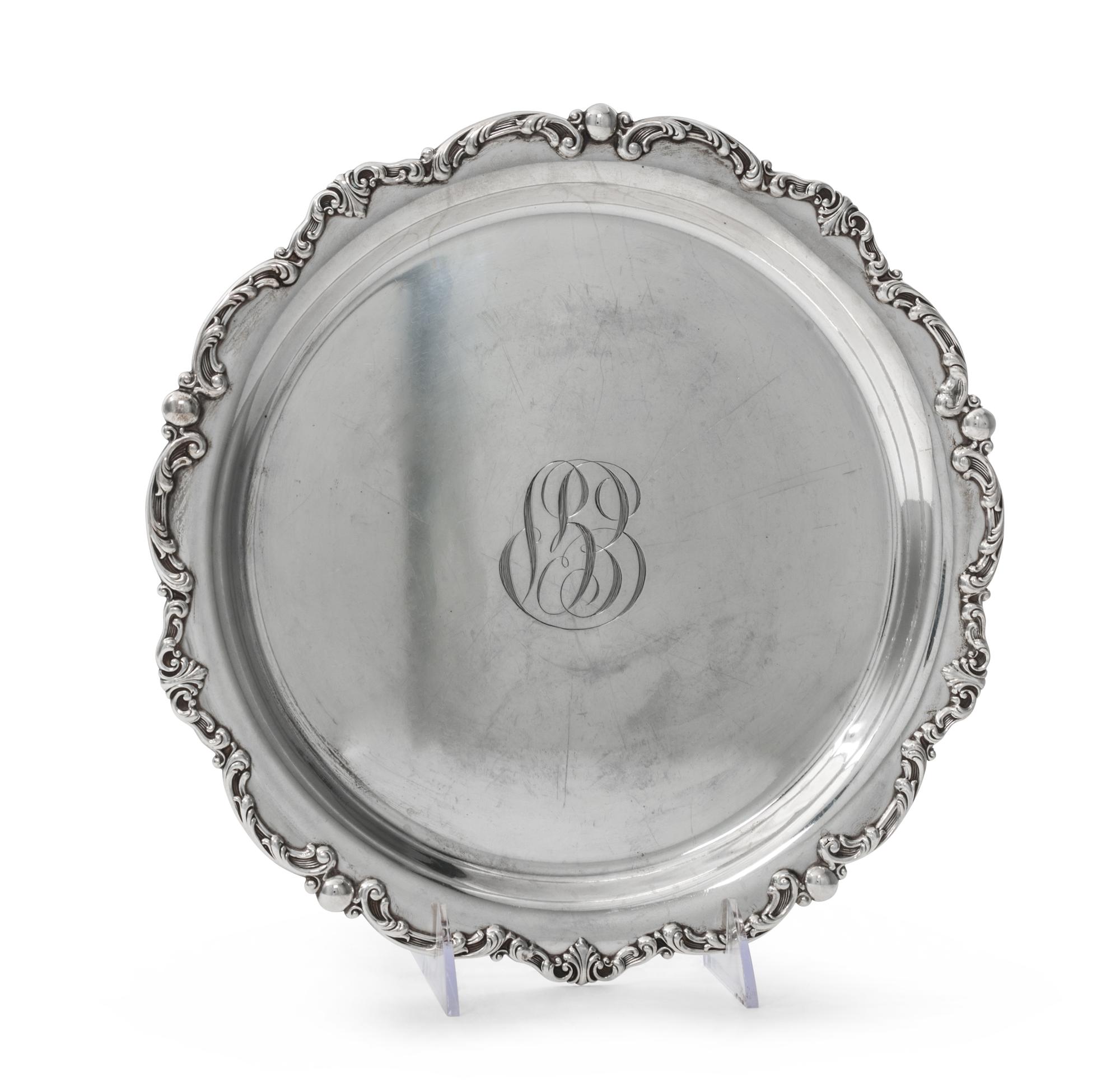 An American Silver Tray, Gorham Mfg. Co., Providence, RI, of circular form with an applied foliate scroll border surrounding a script m