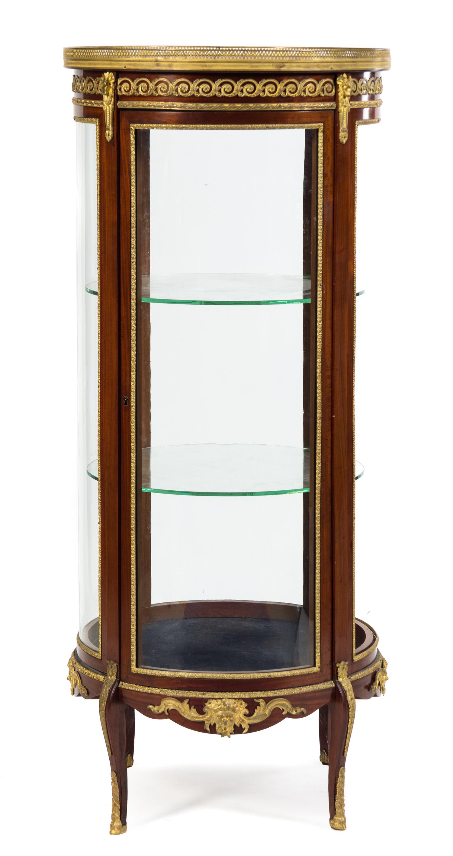 A Napoleon III Gilt Bronze Mounted Mahogany Vitrine Cabinet Height 59 1/4 x diameter of top 25 1/8 inches. — LATE 19TH CENTURY