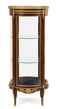 A Napoleon III Gilt Bronze Mounted Mahogany Vitrine Cabinet Height 59 1/4 x diameter of top 25 1/8 inches. — LATE 19TH CENTURY