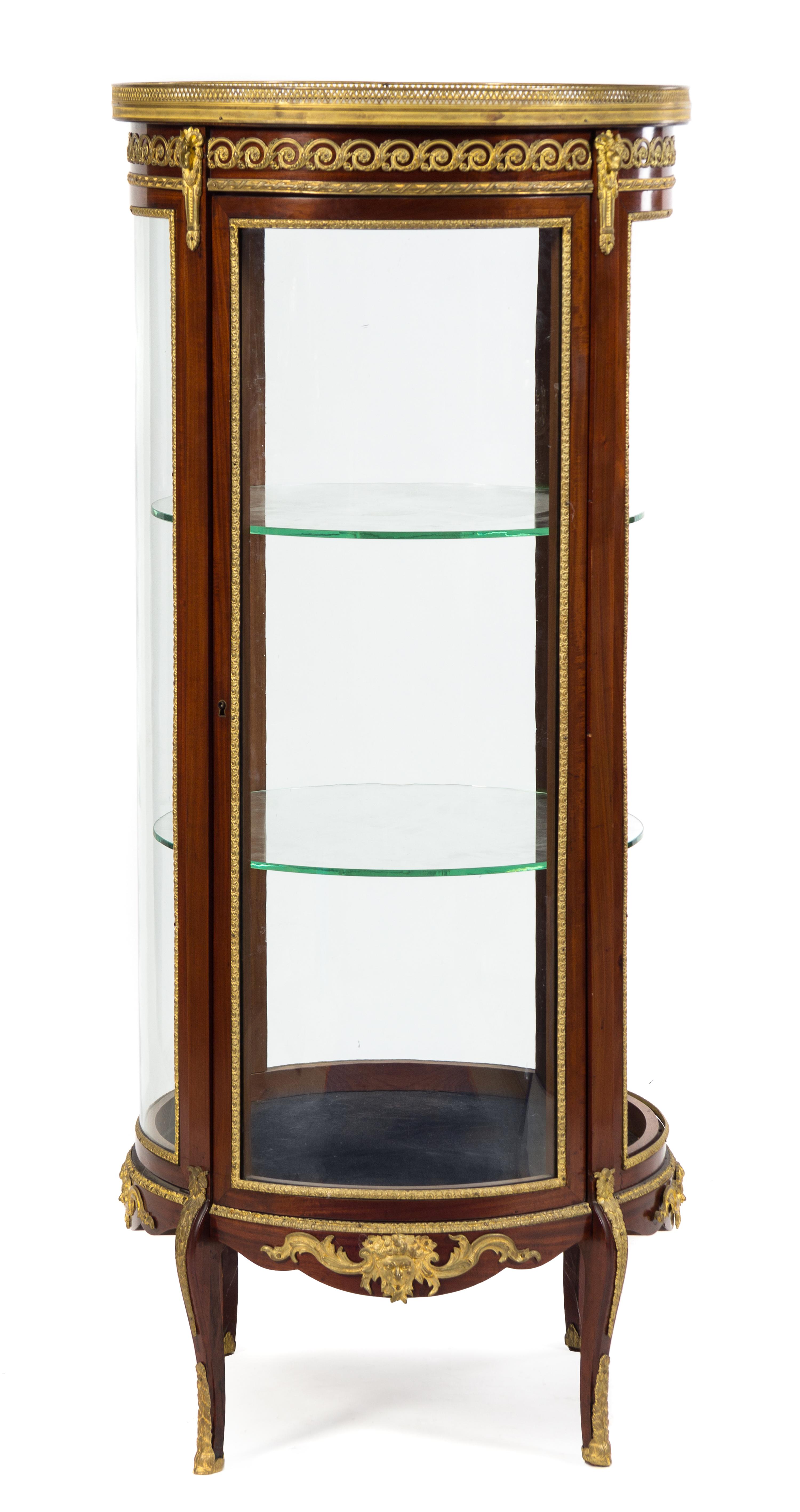A Napoleon III Gilt Bronze Mounted Mahogany Vitrine Cabinet Height 59 1/4 x diameter of top 25 1/8 inches. — LATE 19TH CENTURY