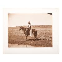 HUFFMAN, Laton Alton (1854-1931). Outdoor portrait of a cowboy on horseback. Miles, MT: Huffman, [ca 1880s].