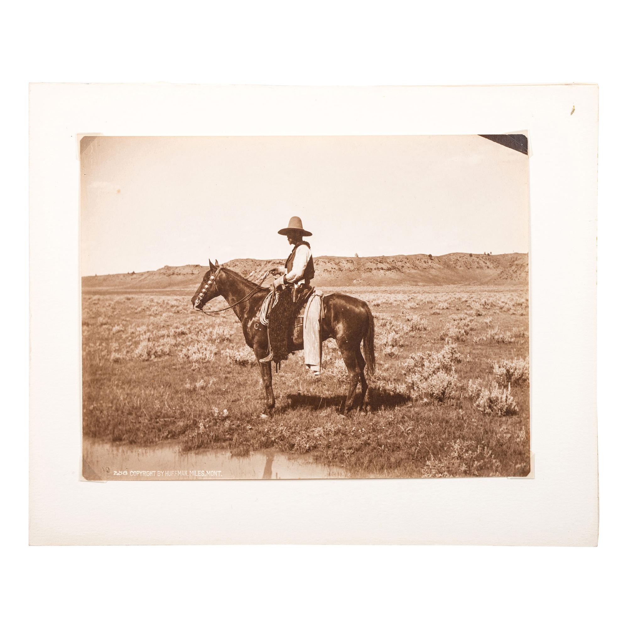 HUFFMAN, Laton Alton (1854-1931). Outdoor portrait of a cowboy on horseback. Miles, MT: Huffman, [ca 1880s].