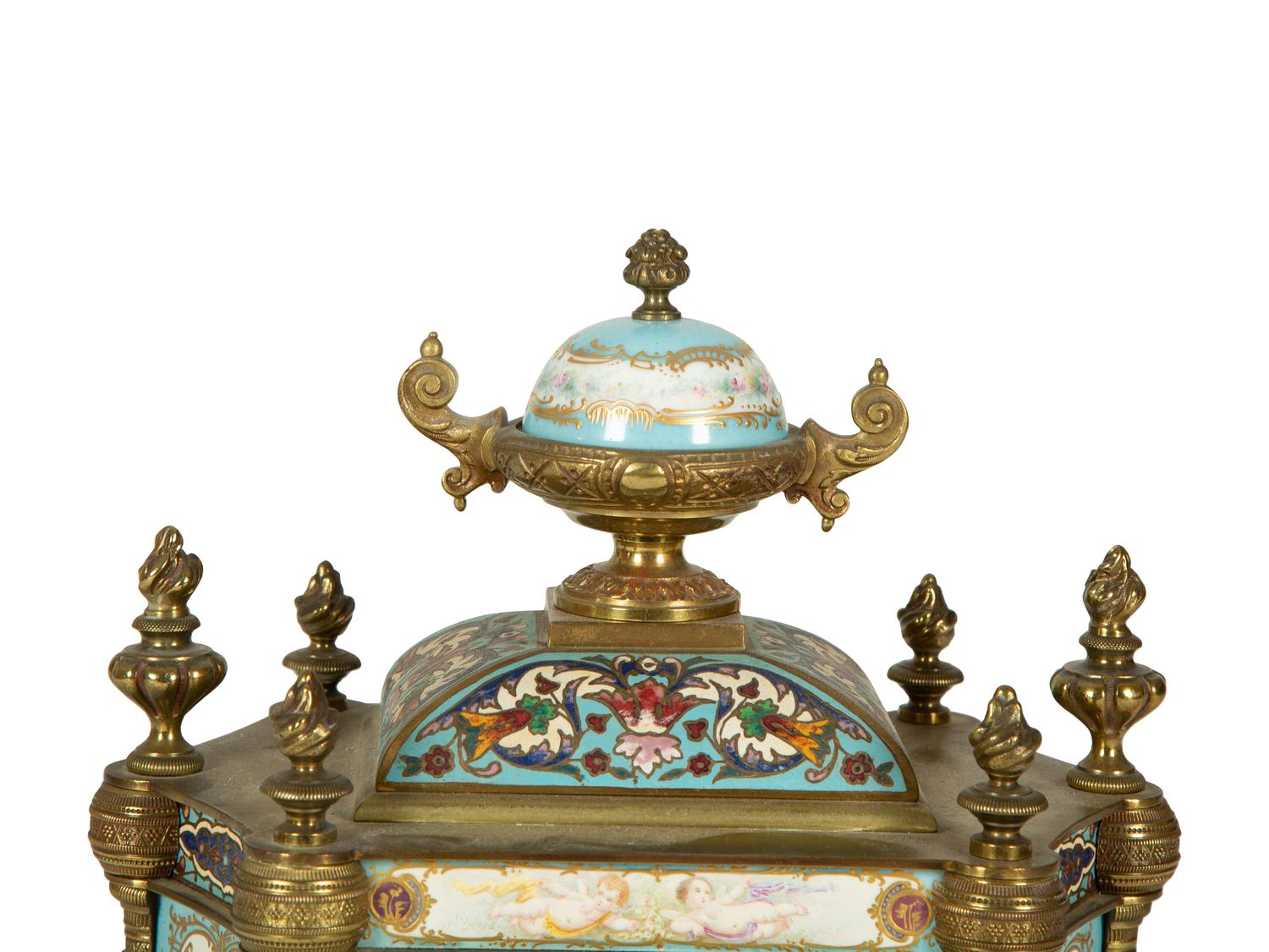 A French Porcelain, Gilt Bronze and Champlevé Clock — CIRCA 1900