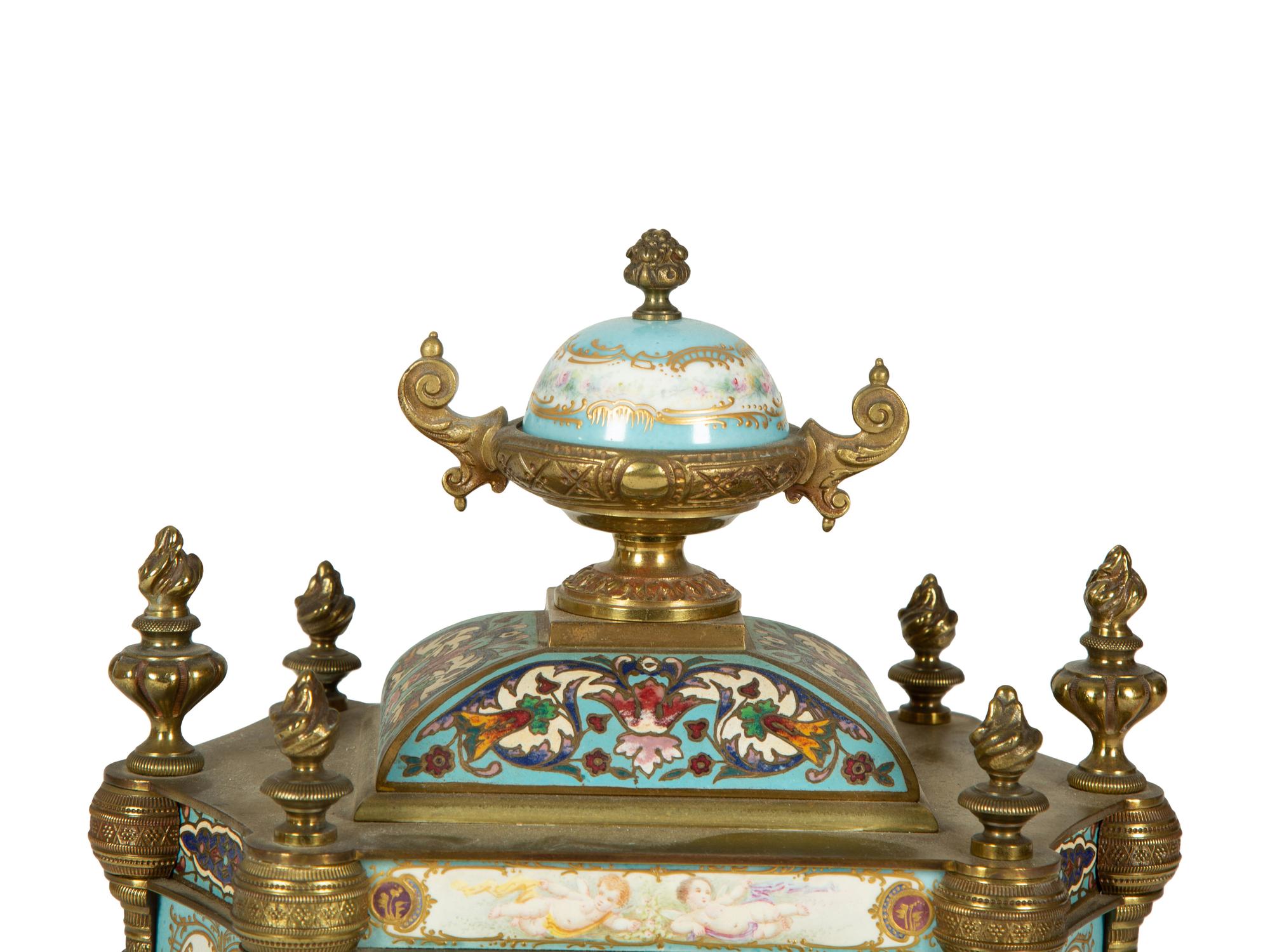 A French Porcelain, Gilt Bronze and Champlevé Clock — CIRCA 1900