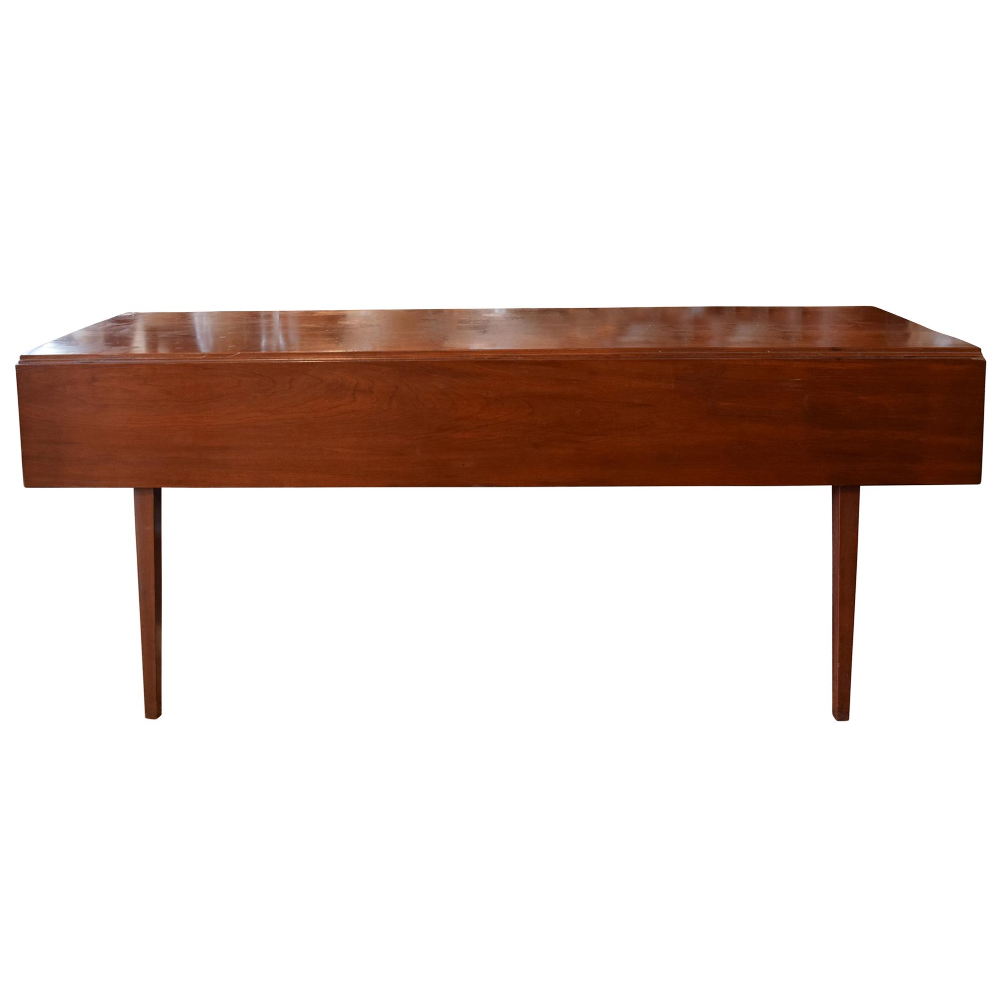 A Mid Century Cherry Drop Leaf Table 71" W x 19.5-39.5" D x 30" H — United States, Mid-20th Century