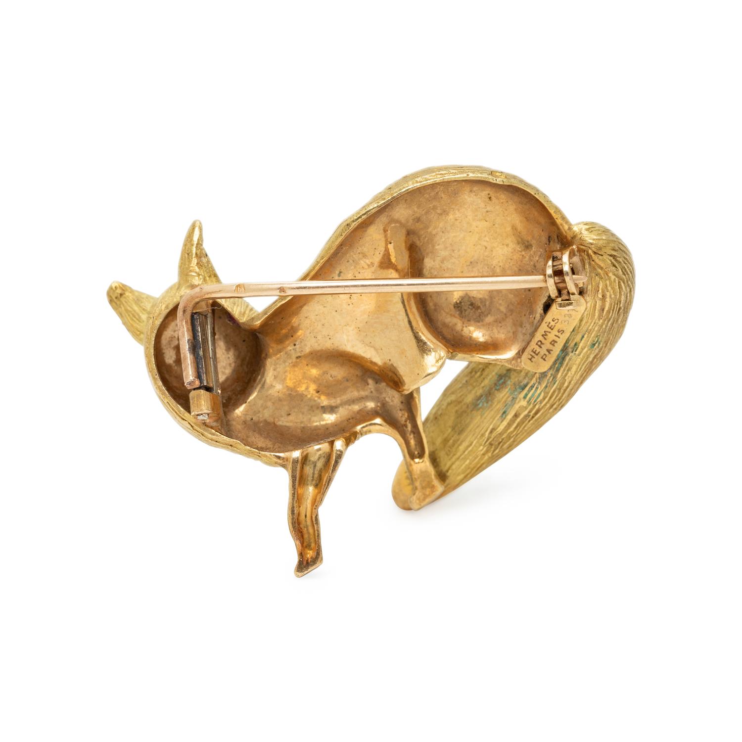 HERMÈS, YELLOW GOLD AND RUBY FOX BROOCH