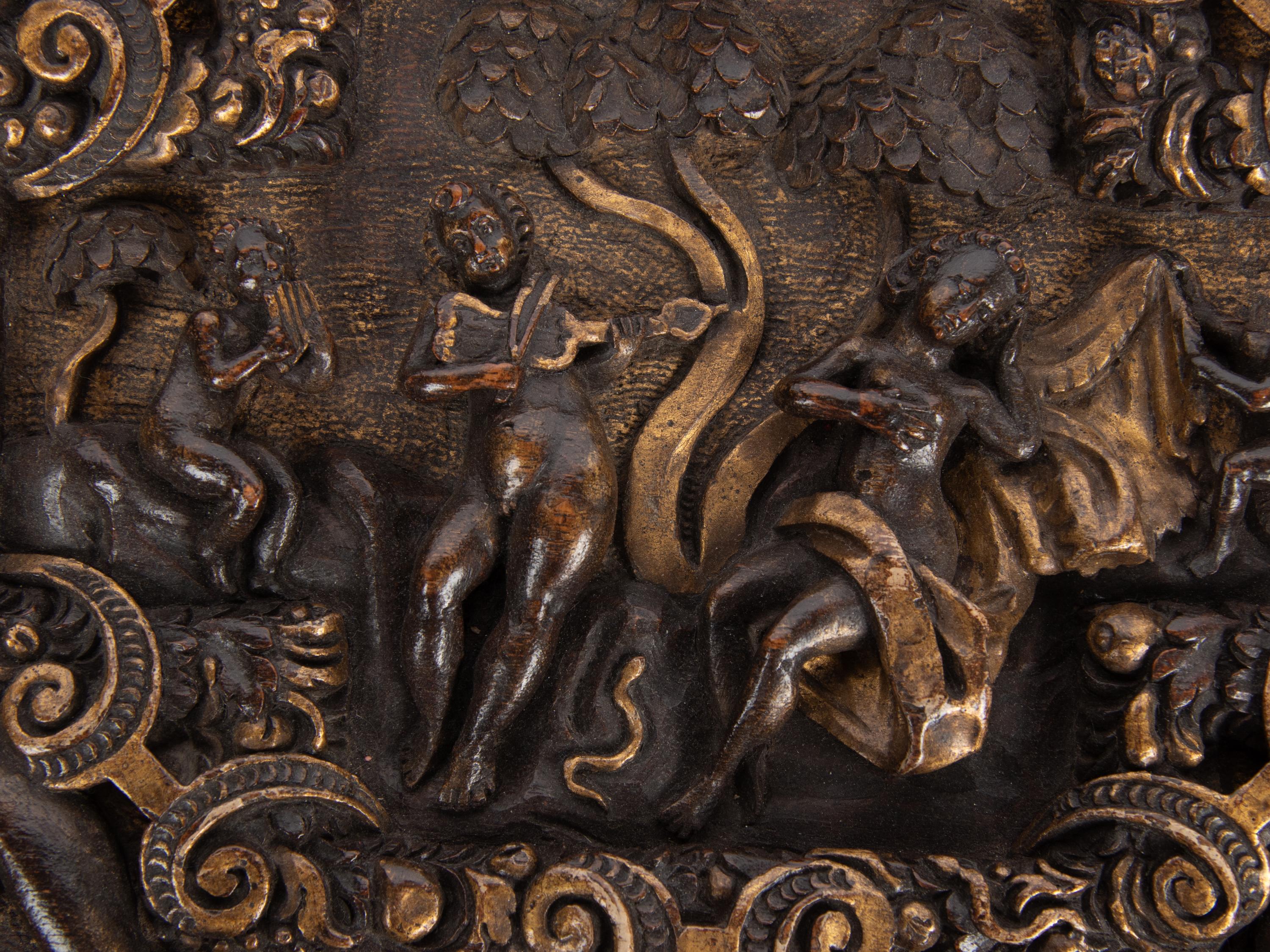 An Italian Parcel Gilt and Carved Walnut Orpheus and Eurydice Casket