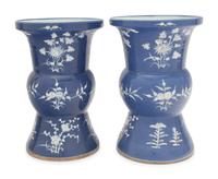 A Pair of Chinese Blue Ground White Slip Decorated Porcelain Spittoons