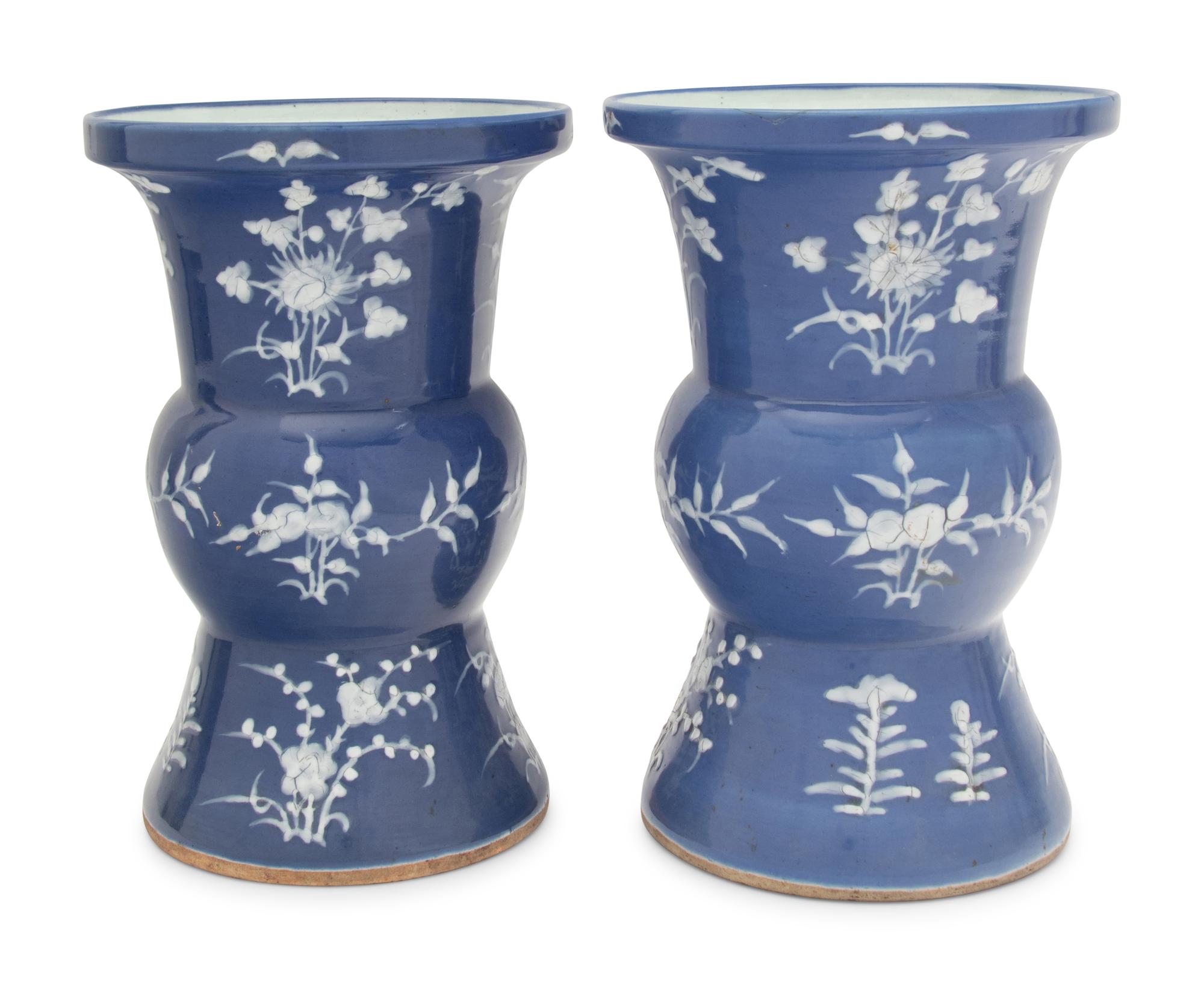 A Pair of Chinese Blue Ground White Slip Decorated Porcelain Spittoons