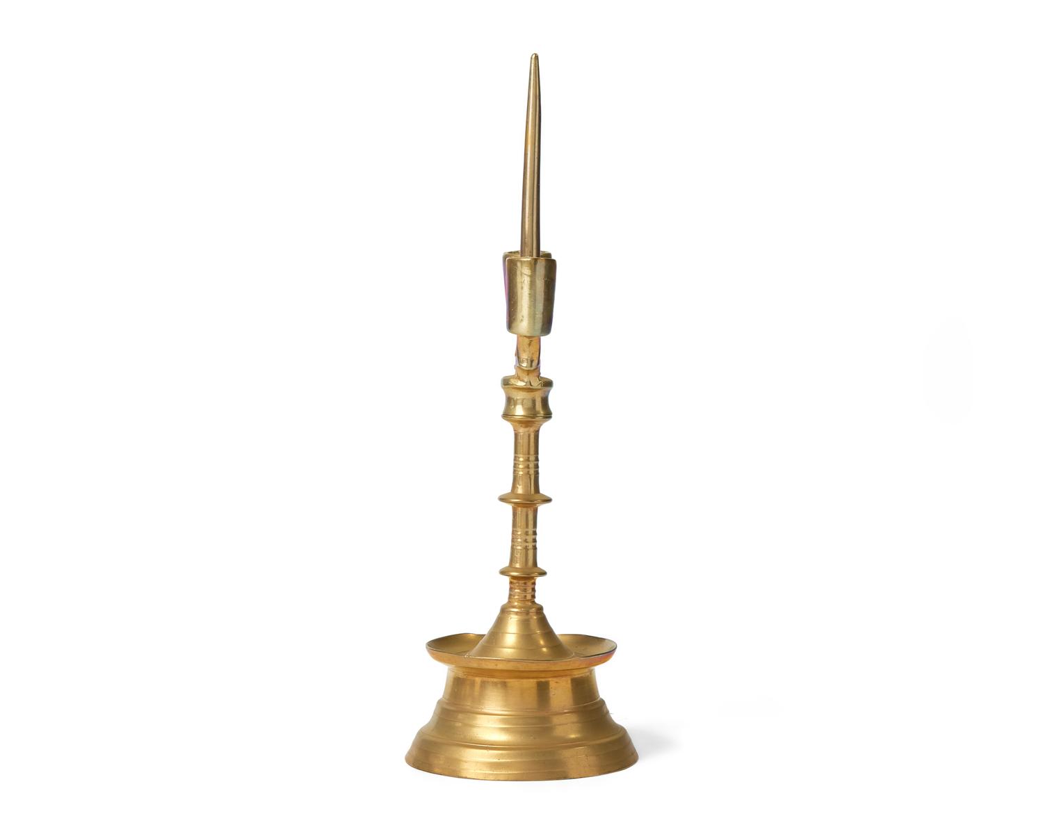 A Flemish Brass Double-Light Candlestick