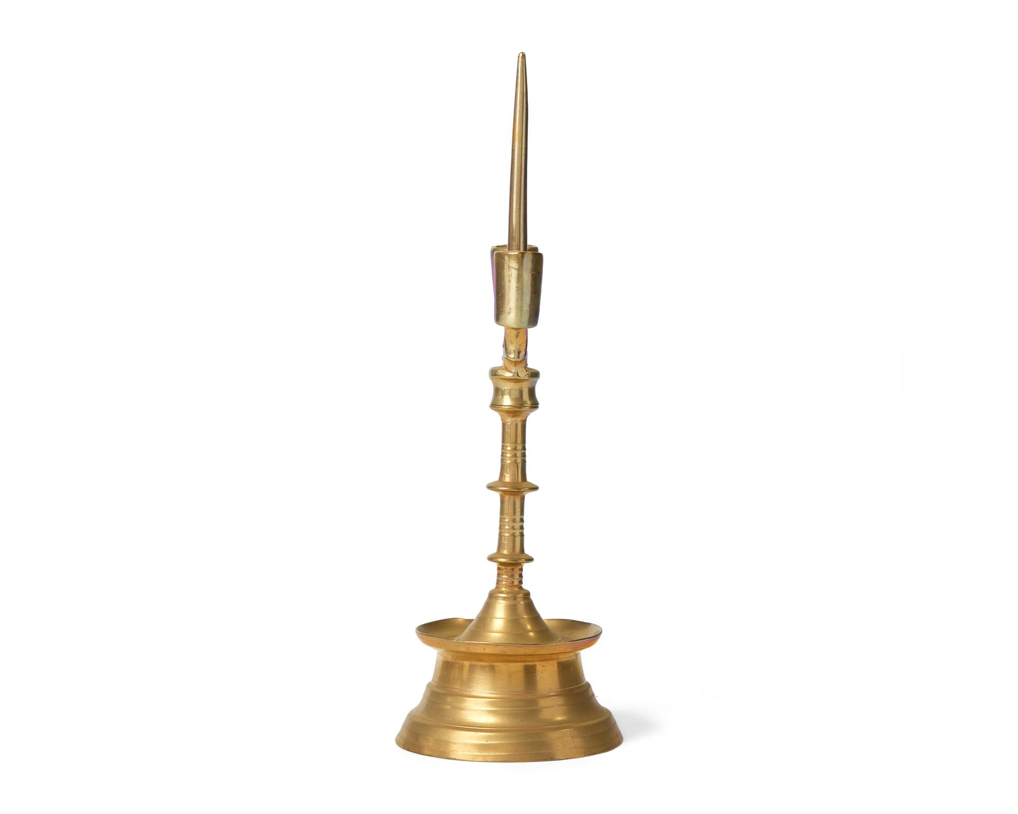A Flemish Brass Double-Light Candlestick