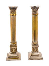 A Pair of Silvered Metal Candlesticks