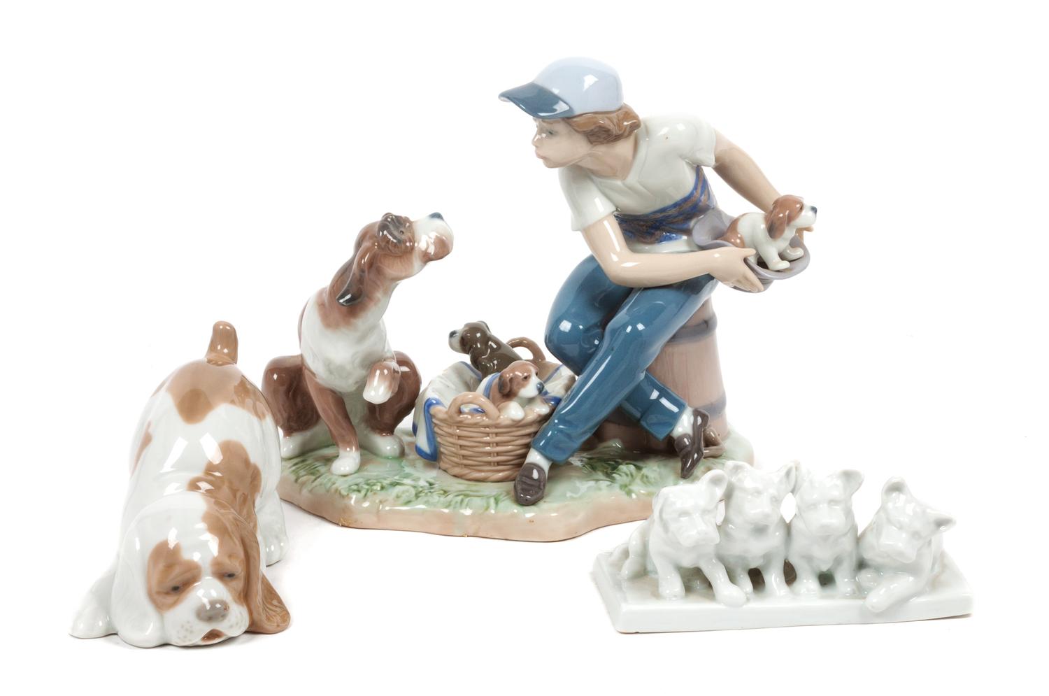 Three Porcelain Dog Figures depicting Various Breeds Width of widest 8 1/2 inches.
