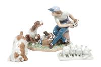 Three Porcelain Dog Figures depicting Various Breeds Width of widest 8 1/2 inches.