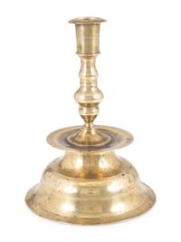 A Continental Brass Heemskirk Bell-Bottom Candlestick