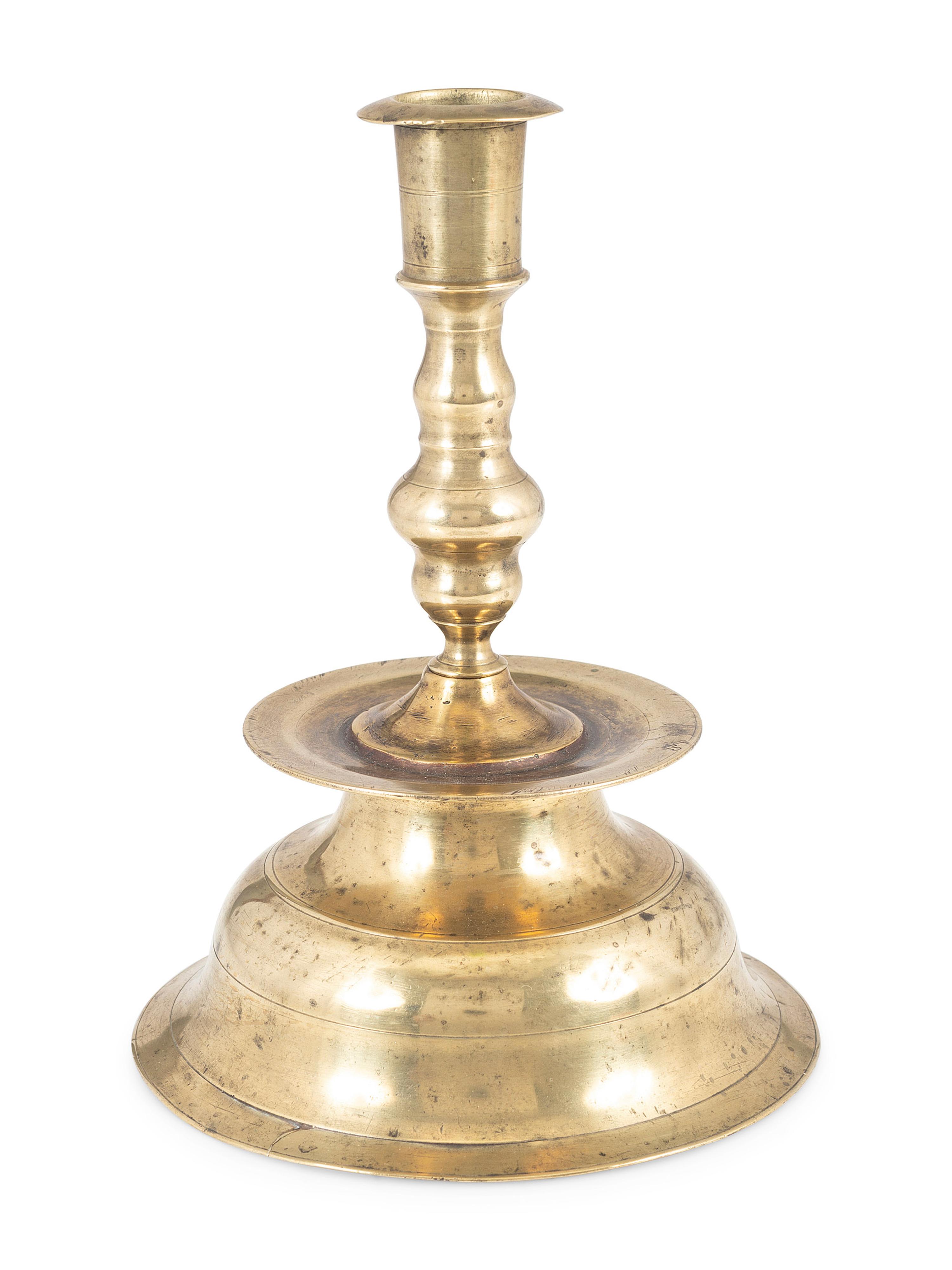 A Continental Brass Heemskirk Bell-Bottom Candlestick
