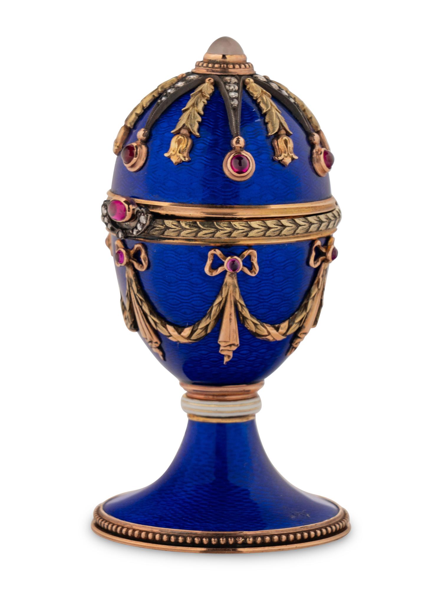 A 14 Karat Vari-Color Gold, Guilloché Enamel, Diamond, and Cabochon Jewel-Mounted Egg-Form Perfume and a Related Guilloché Enamel, 14 Karat Vari-Color Gold, Diamond, and Cabochon-Mounted Surprise Egg