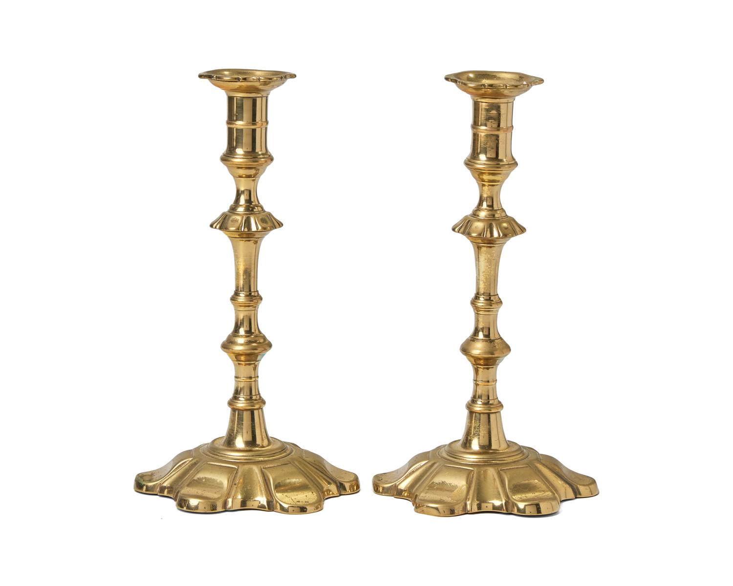 A Group of Four George III Brass Candlesticks
