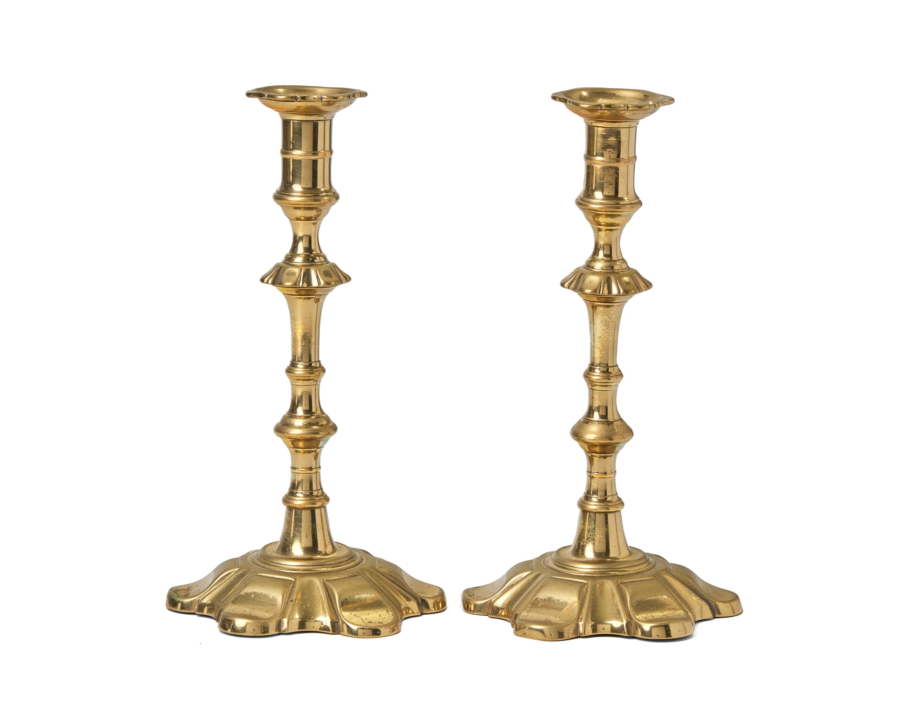 A Group of Four George III Brass Candlesticks
