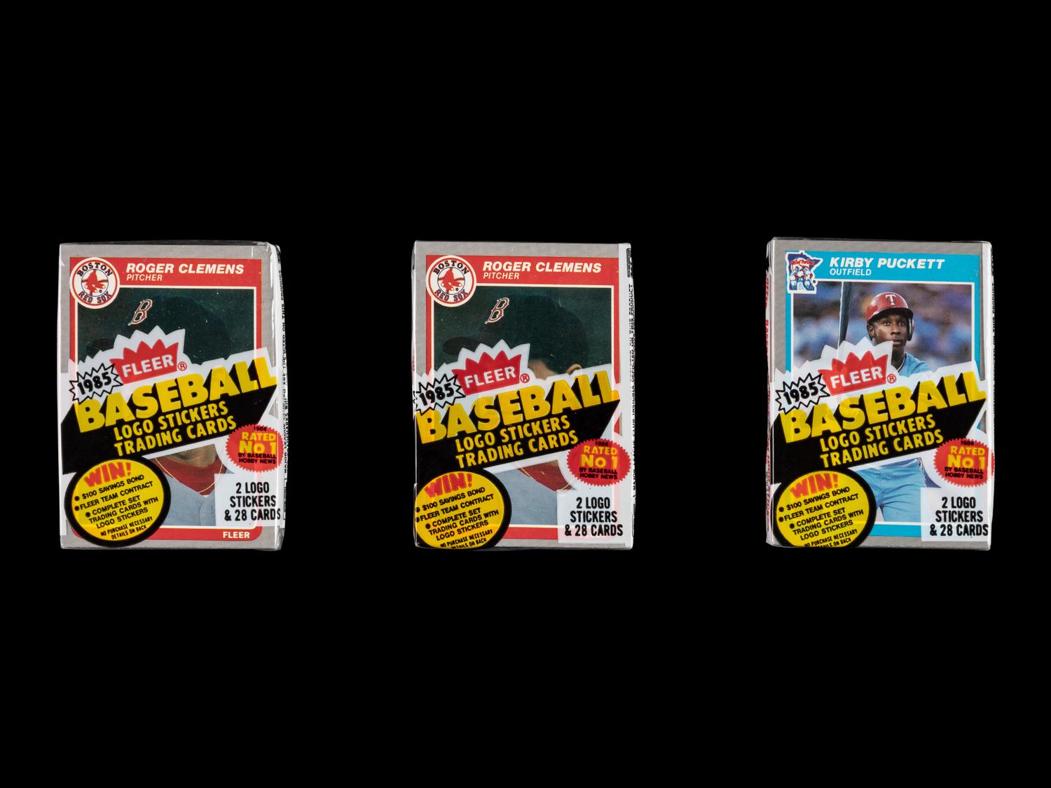 A Collection of Unopened 1985 Fleer Baseball Card Cello Packs with Kirby Puckett and Roger Clemens Rookie Cards Visible (x3)